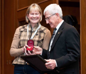 Dr. Wayne Burwash accepts the Alberta Horse Industry Distinguished Service Award from HIAA President Jean Kruse. Supplied photo.