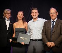 Four people during award ceremony