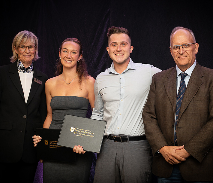 Four people during award ceremony